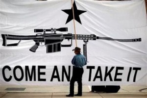 Austin Ehlinger helps hold a banner during a Guns Across America rally at the state capitol, Saturday, Jan. 19, 2013, in Austin, Texas.  Texas officials opposed to new federal gun control proposals plan to speak on the steps of the state Capitol during a pro-Second Amendment rally. The event is one of many rallies planned across the country Saturday. They come four days after President Barack Obama unveiled a sweeping plan to curb gun violence.  (AP Photo/Eric Gay)